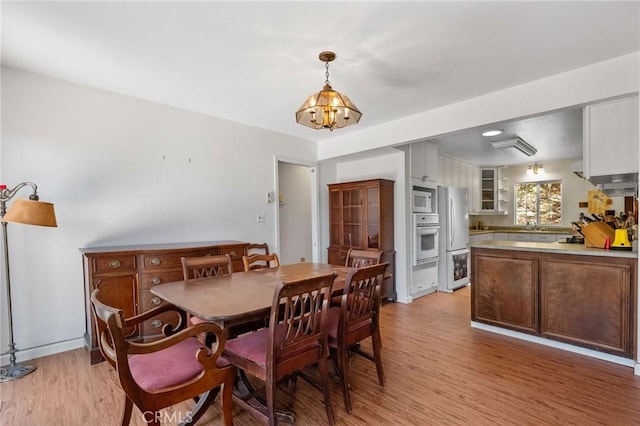19680 Sugarwood Ct, Hidden Valley Lake, CA 95467 - dining room with light wood-type flooring and an inviting chandelier