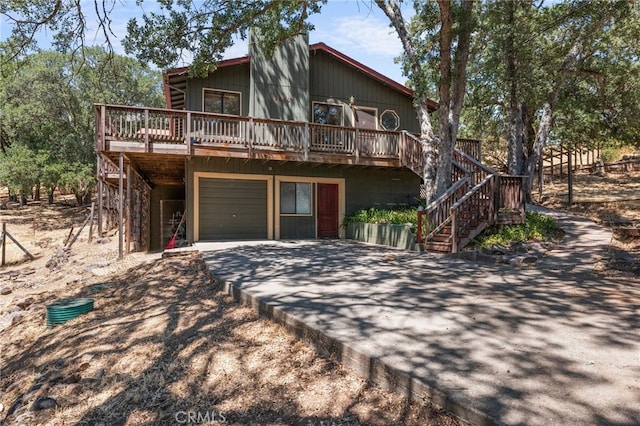 view of front facade with a wooden deck and a garage