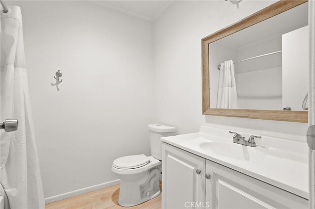 bathroom with wood-type flooring, vanity, and toilet