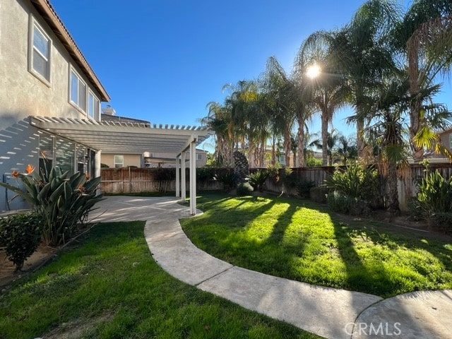 view of yard with a pergola and a patio area