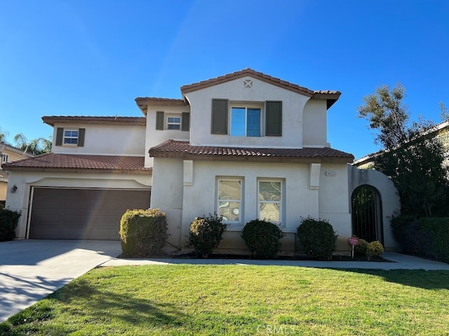 mediterranean / spanish-style house with a garage and a front lawn