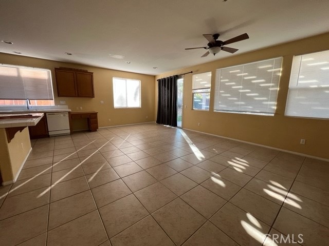 unfurnished living room featuring ceiling fan and light tile patterned floors