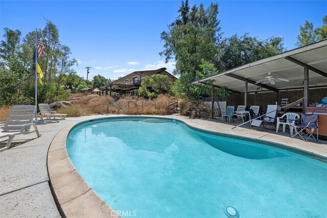 view of pool with ceiling fan and a patio area