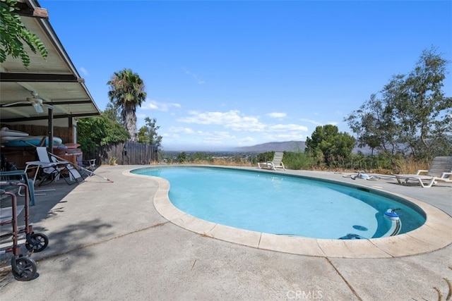 view of swimming pool featuring a patio and a mountain view