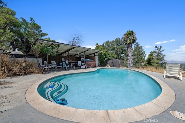 view of swimming pool featuring ceiling fan and a patio area