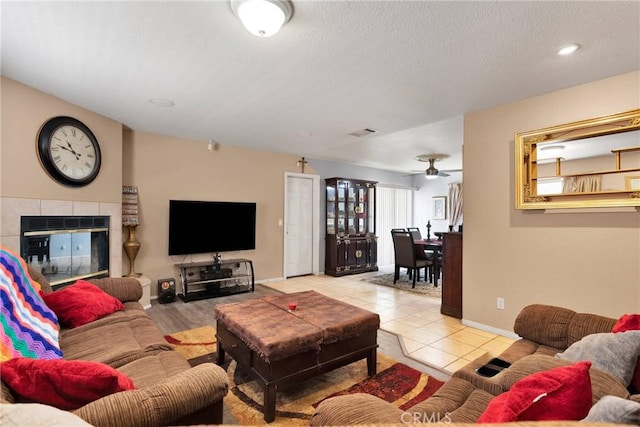 tiled living room featuring a fireplace