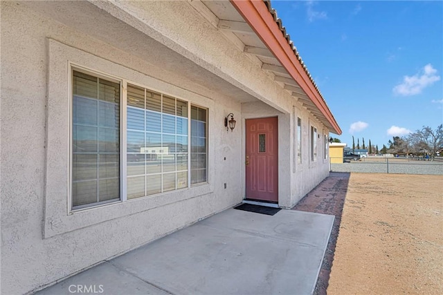 view of exterior entry with a patio