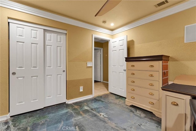 unfurnished bedroom featuring crown molding, ceiling fan, and a closet