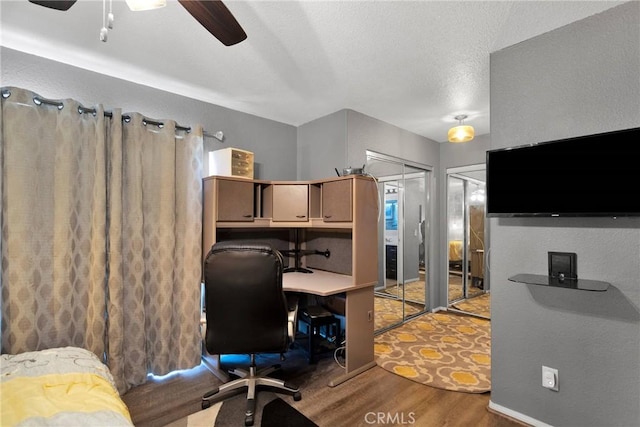 office area with hardwood / wood-style flooring, a textured ceiling, and ceiling fan