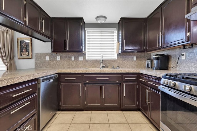 kitchen with tasteful backsplash, sink, stainless steel appliances, and light tile patterned flooring