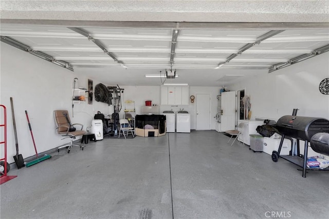 garage featuring washing machine and dryer and a garage door opener