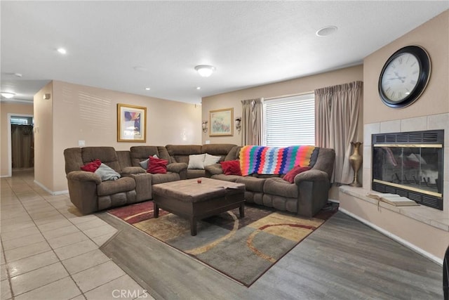 tiled living room featuring a fireplace