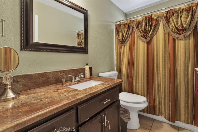 bathroom with a shower with curtain, tile patterned floors, toilet, and vanity