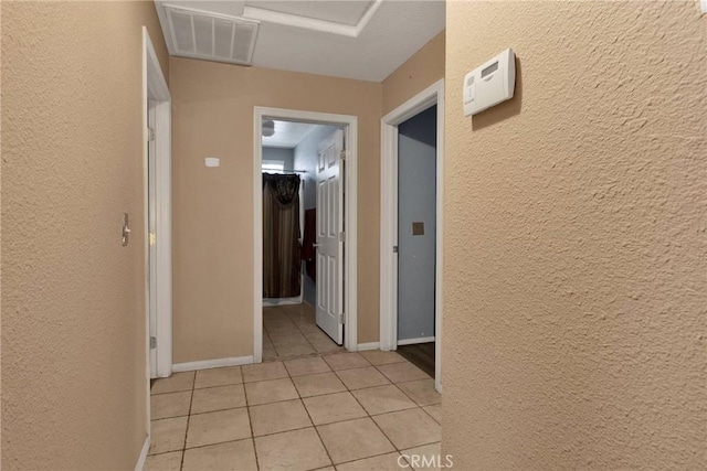 hallway with light tile patterned floors