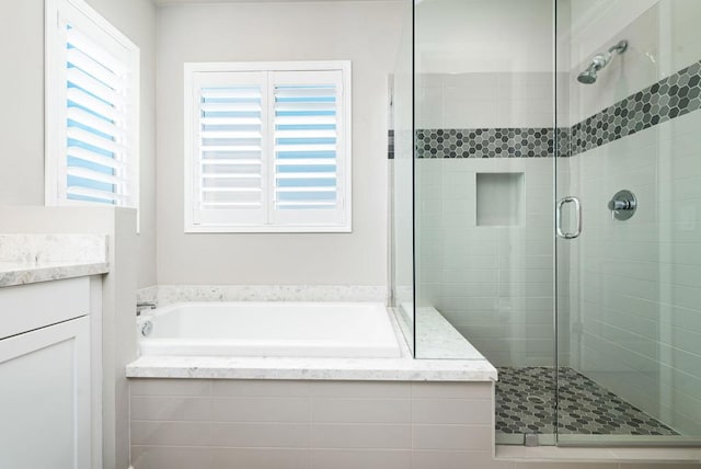 bathroom featuring vanity and separate shower and tub