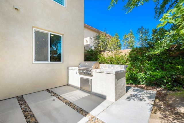 view of patio with area for grilling and grilling area