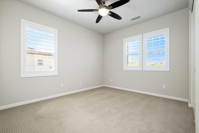 carpeted empty room featuring ceiling fan