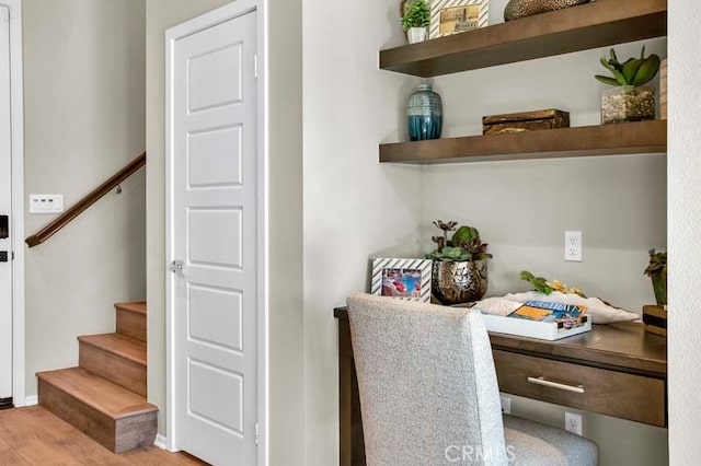 home office with light hardwood / wood-style flooring