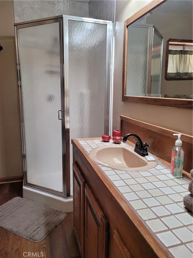 bathroom with vanity and a shower with shower door