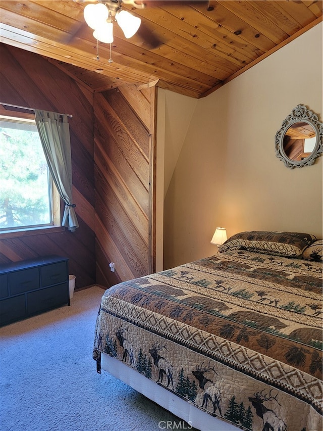 bedroom with wooden ceiling, carpet flooring, wooden walls, and ceiling fan