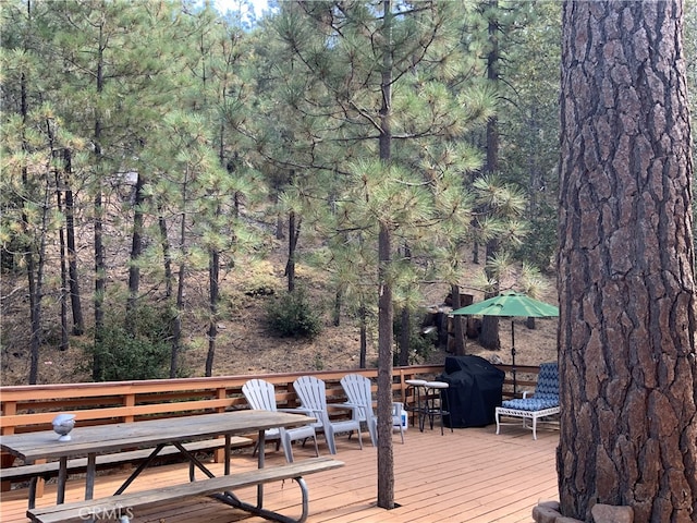 wooden terrace featuring grilling area