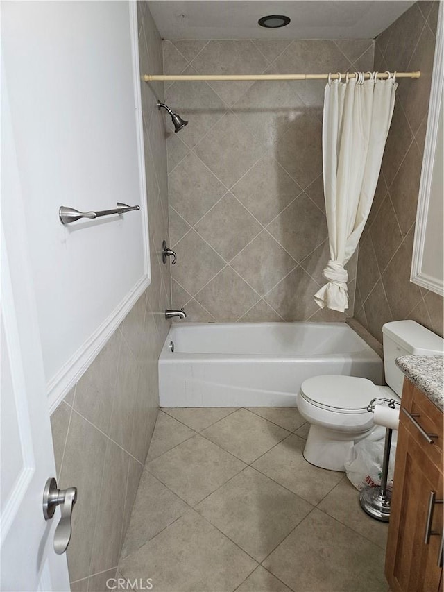 full bathroom featuring vanity, tile patterned floors, toilet, tile walls, and shower / tub combo with curtain