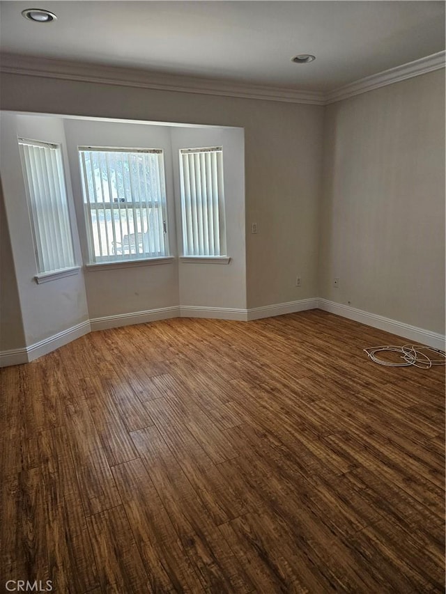 unfurnished room with hardwood / wood-style floors and ornamental molding