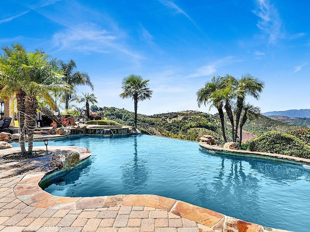 view of swimming pool featuring a mountain view