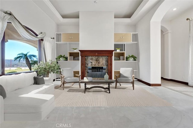 sitting room featuring a fireplace, light carpet, and a tray ceiling