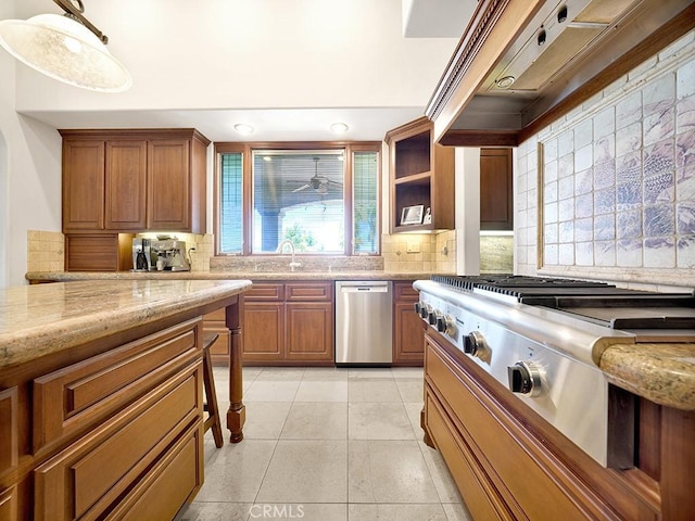 kitchen featuring light stone countertops, ventilation hood, stainless steel appliances, and decorative backsplash