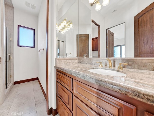 bathroom featuring vanity, tile patterned floors, and a shower with shower door