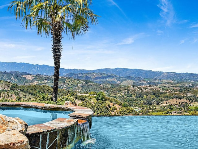 exterior space with a water and mountain view