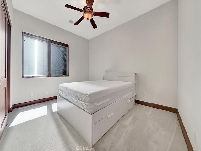 bedroom featuring ceiling fan and light carpet