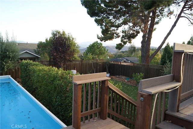 view of swimming pool with a wooden deck