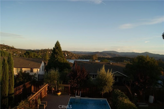 view of swimming pool featuring a deck with mountain view