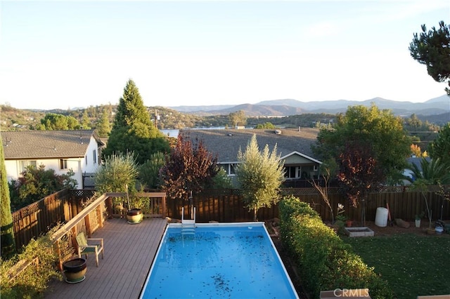 view of swimming pool with a deck with mountain view