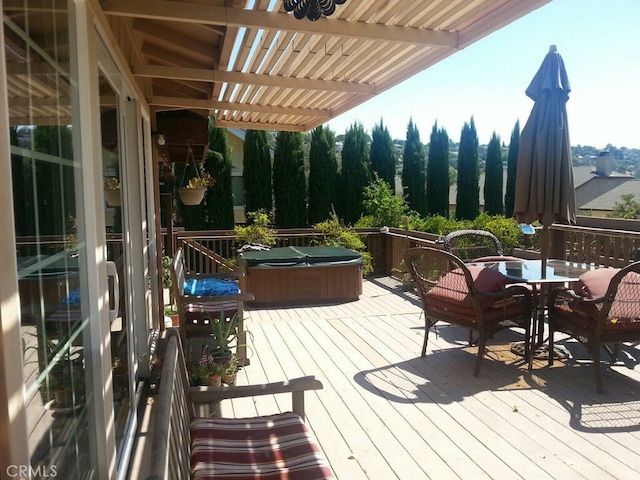 wooden deck featuring a hot tub