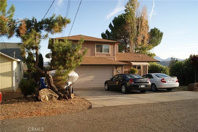 view of front of property with a mountain view and a garage