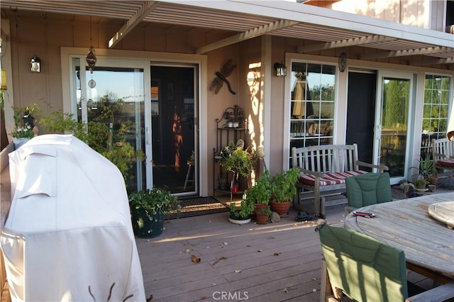 wooden deck featuring a grill