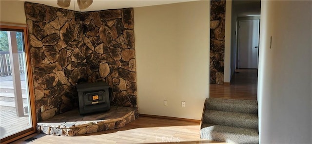 living room featuring wood-type flooring and a wood stove