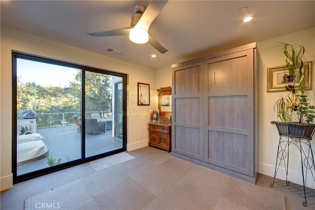 entryway with light colored carpet and ceiling fan