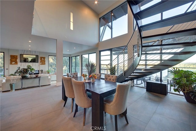 tiled dining space with a towering ceiling