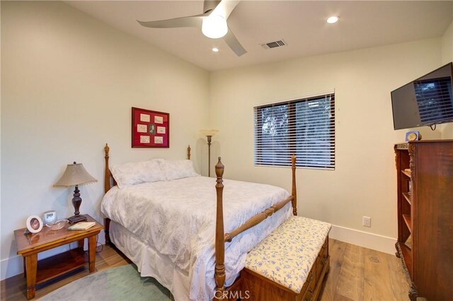 bedroom featuring ceiling fan and light hardwood / wood-style flooring