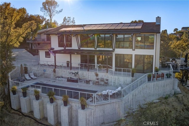 rear view of property featuring a patio area