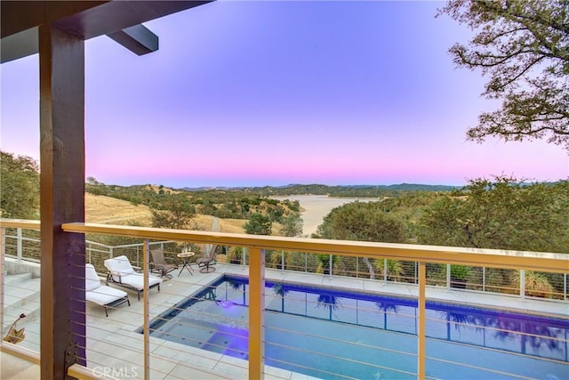 pool at dusk with a patio