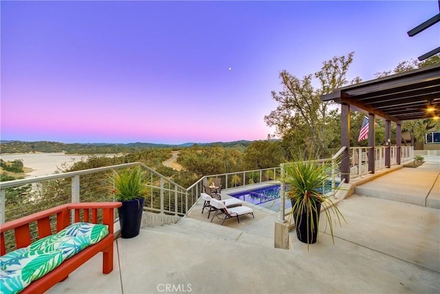 view of patio terrace at dusk