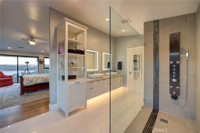 bathroom featuring hardwood / wood-style flooring, vanity, and a shower