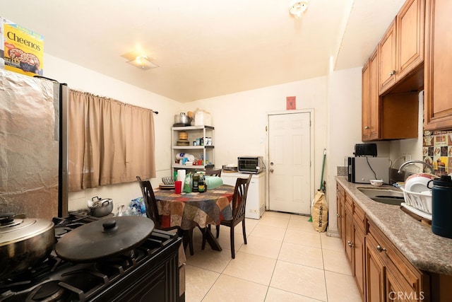 kitchen featuring light tile patterned floors and sink