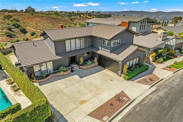 view of front of property featuring a garage and a mountain view