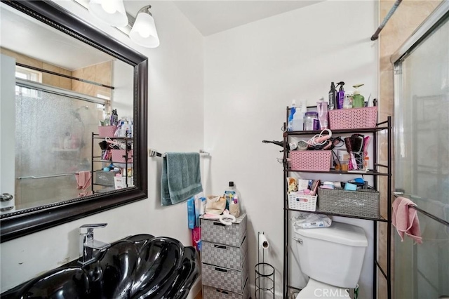 bathroom featuring toilet and walk in shower